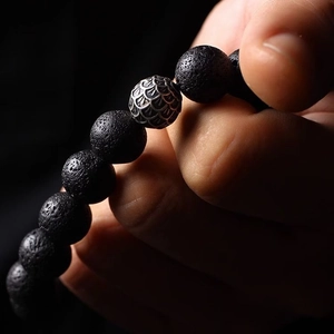 Retro black lava stone beaded bracelet with silver dragon scale metal charm detail