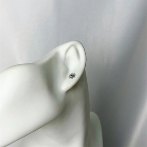 Minimalist silver sunburst stud earring with a sharp punk star design for men and women