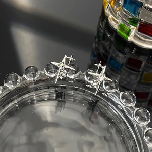 Elegant starburst stud earrings with silver cross design and sparkling cubic zirconia stones