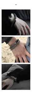 Close-up of double-layered natural stone and silver metal chain bracelet for men