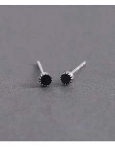 Macro detail of 925 sterling silver stamp on minimalist black crown stud earrings