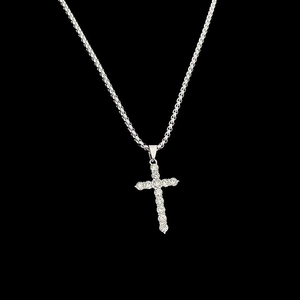 Close-up of a silver-tone titanium cross pendant with sparkling inset crystals