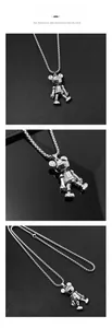 Detail of silver movable mechanical bear pendant on pearl box chain necklace