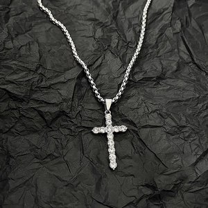 Men's titanium steel cross necklace with crystal pavé and box chain on black background