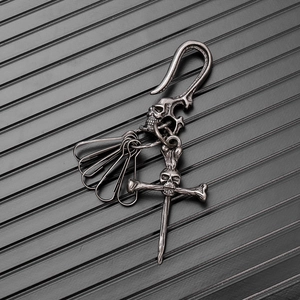 Detail of vintage gothic skull keychain with cross bone pendant and antique silver finish