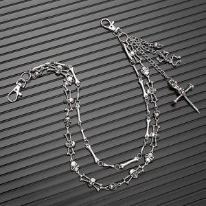Detail of silver skull trouser chain with multi-layer metal links and skeleton charms
