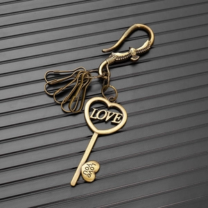 Close-up of vintage bronze heart-shaped key pendant with eagle hook and LOVE engraving