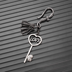 Detail of vintage silver punk keychain with eagle hook and heart LOVE key pendant