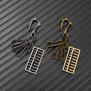 Detail of vintage metal abacus keychains in gun black and bronze with dragon hooks