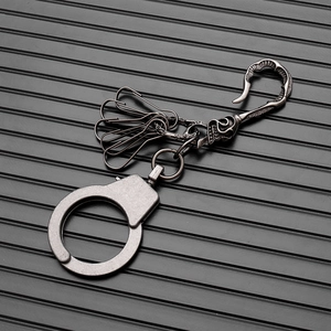 Detailed view of punk style metal handcuffs keychain with vintage silver finish and hooks