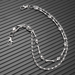 Detail of silver double-layered punk waist chain featuring skull and bone metal charms