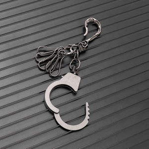 Close-up of hip-hop style handcuff pendant keychain with industrial metal finish
