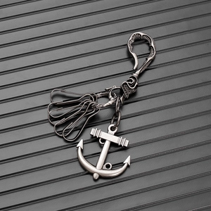 Close-up of retro punk anchor keychain with bone-shaped main hook and silver finish