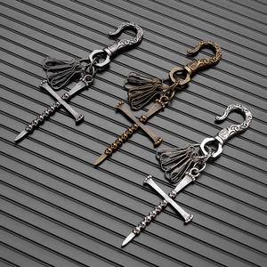 Retro punk cross keychain with skull detail in gunmetal, bronze, and silver finishes