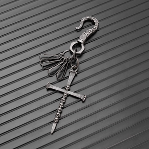 Macro shot of vintage punk skull cross keychain with intricate carved metal hook detail