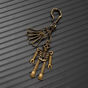Macro shot of retro brass skeleton robot keychain with mechanical punk vintage finish