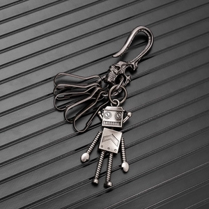 Macro shot of vintage robot pendant keychain with skull hook and five functional rings