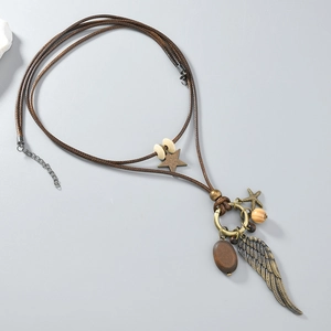 Detail of vintage bohemian necklace with bronze feather charms and wooden beads