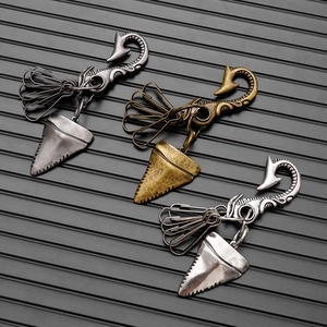 Vintage shark tooth pendants on industrial metal keychains in three antique finishes