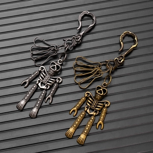 Close-up of vintage punk skull keychains with movable limbs in silver and bronze finish