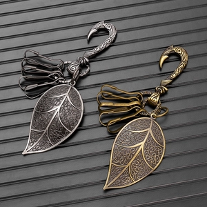 Detail of vintage leaf pendants with intricate knots on s-hook in silver and bronze finish