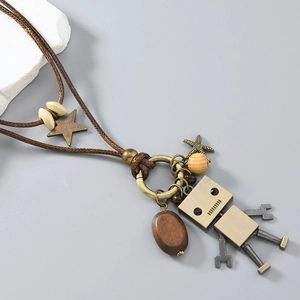Detail of movable vintage robot pendant with wooden beads and bronze charms on sweater chain
