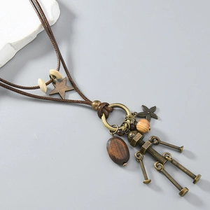 Detail of vintage industrial robot pendant with wooden beads on brown woven cord necklace