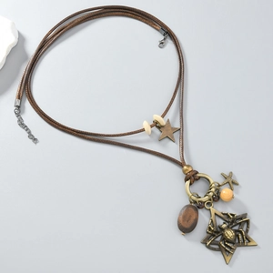 Detailed view of vintage spider pendant with bronze star, wooden beads and woven rope chain