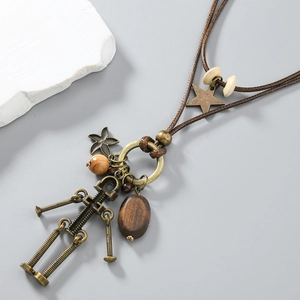 Close-up of vintage robot pendant necklace with antique bronze hardware and wood beads