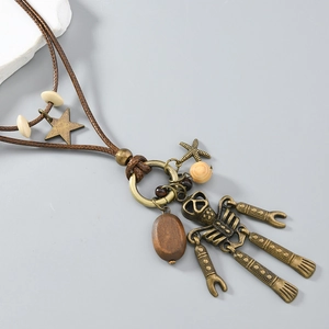 Macro shot of retro bronze robot pendant with nautical charms on woven leather cord