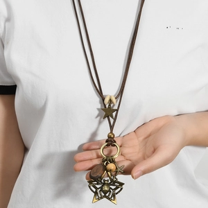 Retro long necklace with bronze spider pendant and starfish charms on brown cord
