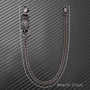 Detail of 69cm punk skull pants chain featuring gunmetal Cuban links and leather charm