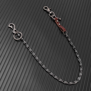 Detail of punk hip hop waist chain with leather strap and carved metal fishhook buckle