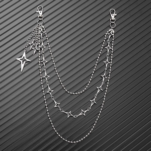 Detail of silver multilayer waist chain featuring star pendants and punk metal link chains