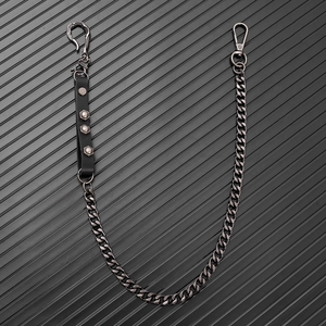 Detail of punk style metal waist chain featuring a snake head hook and studded leather