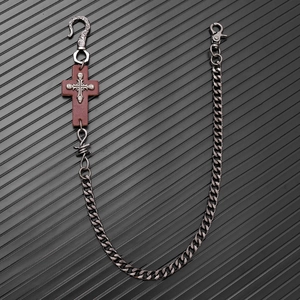 Detail of gothic punk trousers chain with leather cross and skull pendant elements