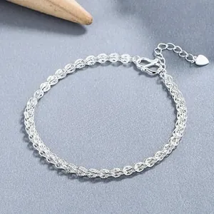 Detail of silver phoenix-tail woven bracelet with adjustable chain and heart charm