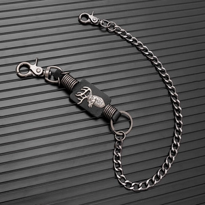Detail view of punk style gun-black chain with a stag head leather charm and metal clasps