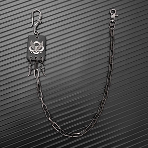 Detail of gothic metal wallet chain with eagle hook, leather patch and claw charms