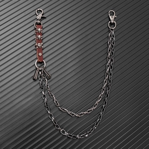 Close-up of punk waist chain featuring double metal links and skull leather accents