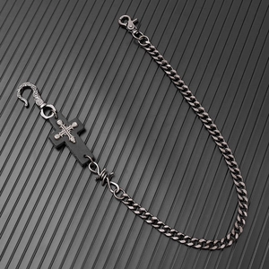 Detail of punk hip-hop wallet chain featuring leather cross and barbed wire design
