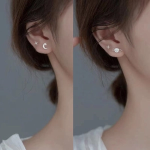 Detail of S925 silver minimalist earring set featuring star, moon, and planet motifs