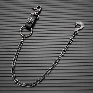 Detail of gothic pants chain with skull leather connector and eagle hook in gunmetal finish