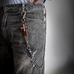 Punk silver pants chain with cross skull pendant on grey denim for street style