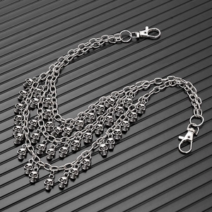 Close-up of multi-layered punk trousers chain with detailed silver skull charms and clasps