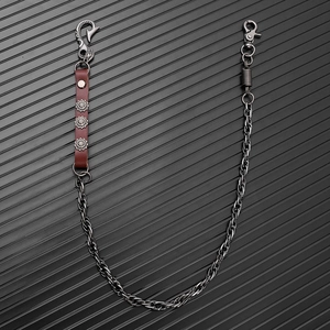 Macro detail of punk wallet chain with twisted links and sunflower leather studs