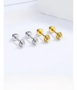 Macro shot of 925 sterling silver barbell screw back earrings in gold and silver finish