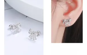 Detailed view of sterling silver hollow bow earrings with threaded screw backs on a model