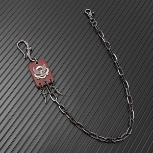 Detailed view of punk hip-hop pants chain featuring eagle badge and claw charms
