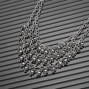 Detail of multi-layer punk skull chains in antique silver finish for hip-hop accessories